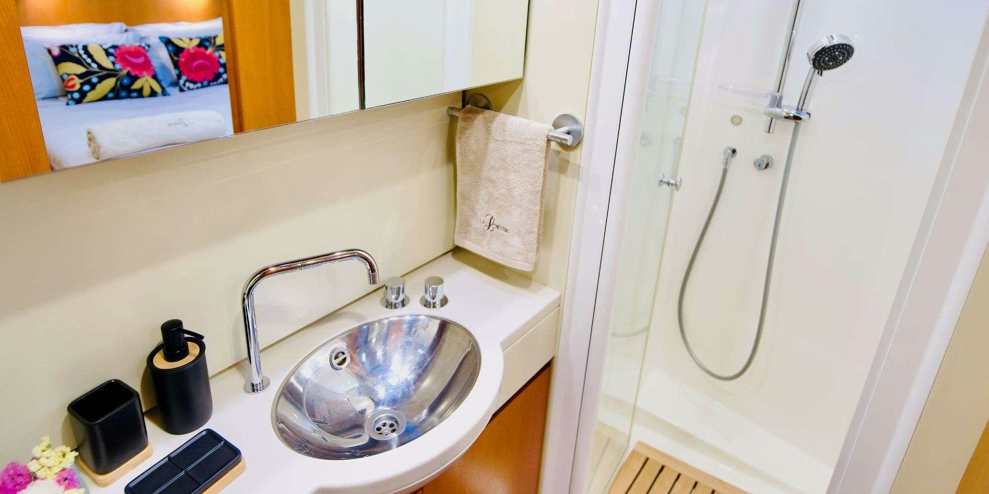 a bathroom with a sink and a shower aboard LA LOEVIE Yacht for Charter