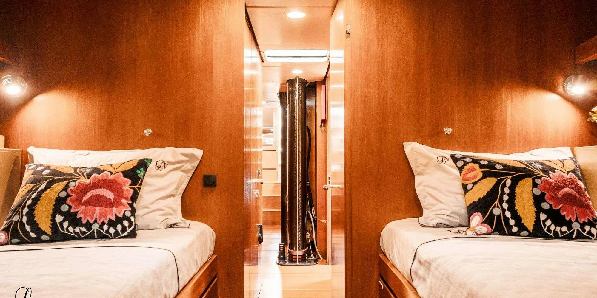 a bedroom with a bed and a closet aboard LA LOEVIE Yacht for Charter