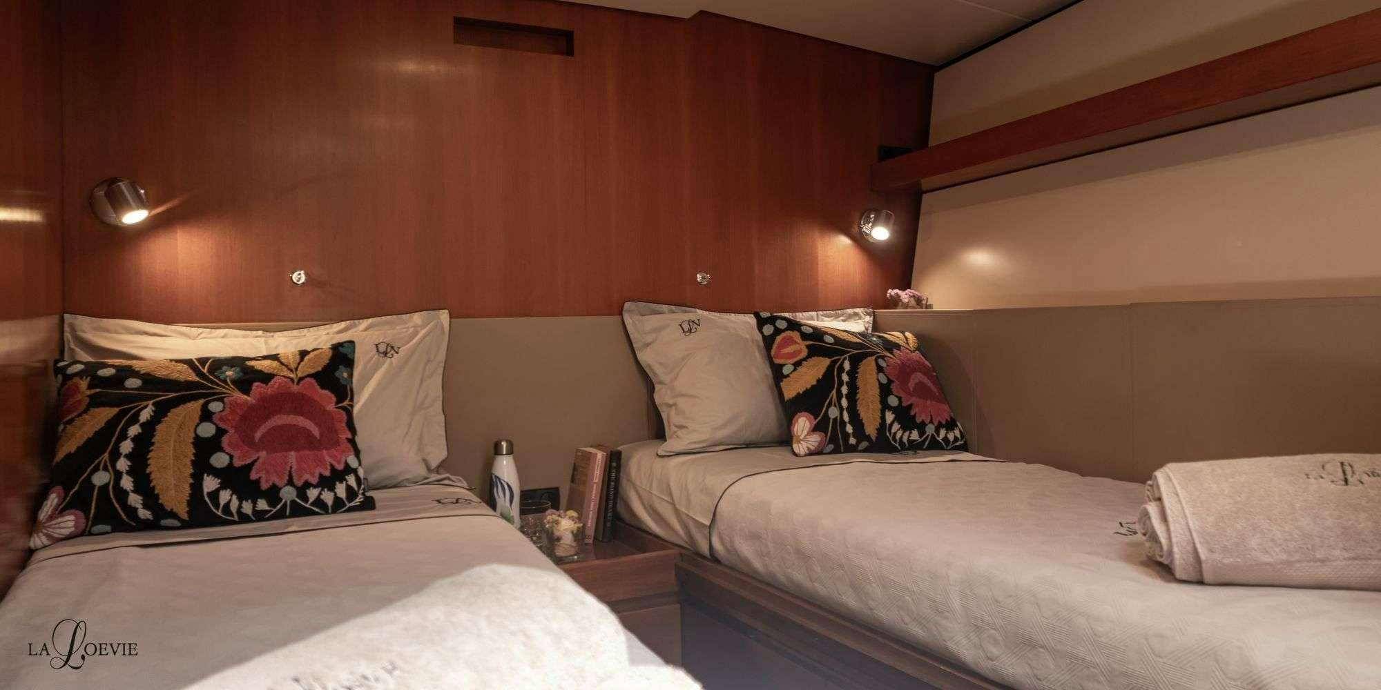 a couple of beds in a room aboard LA LOEVIE Yacht for Charter