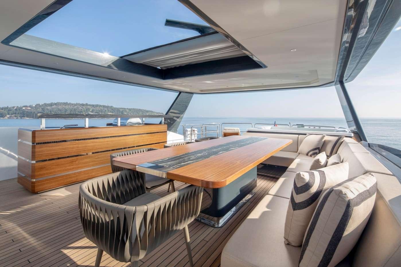 a room with a couch and a table and a chair aboard MAJERA Yacht for Charter