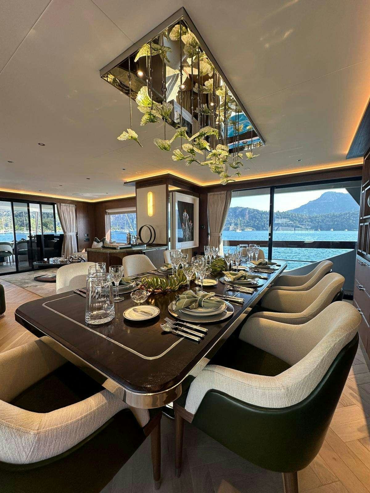 a dining room with a large window aboard MAJERA Yacht for Charter