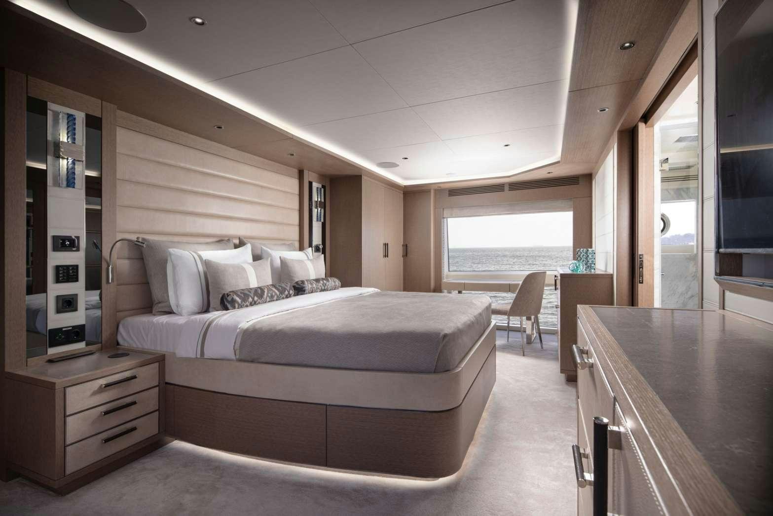 a bedroom with a bed and a desk aboard MAJERA Yacht for Charter