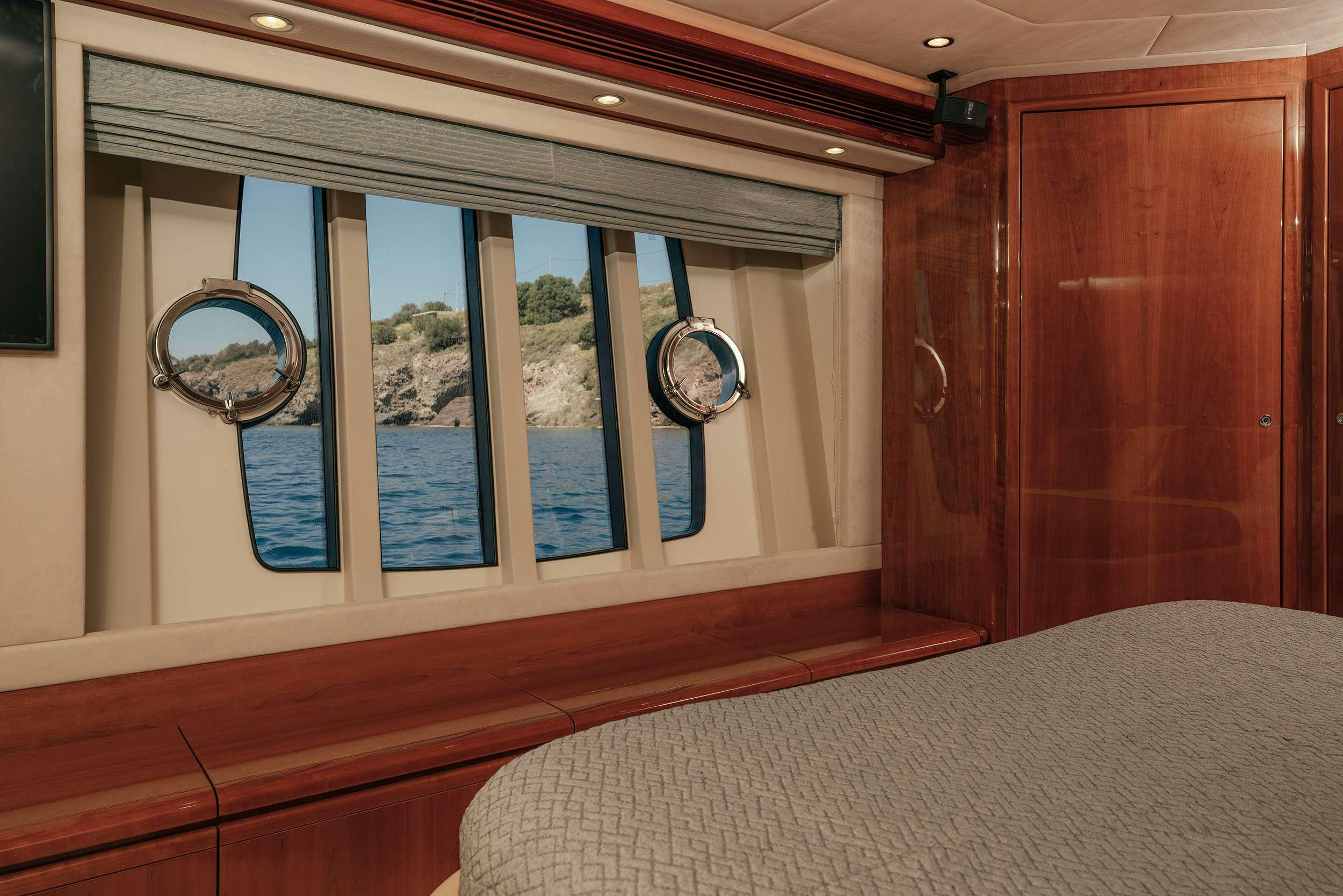 a room with a bed and a window aboard LIDIA Yacht for Charter