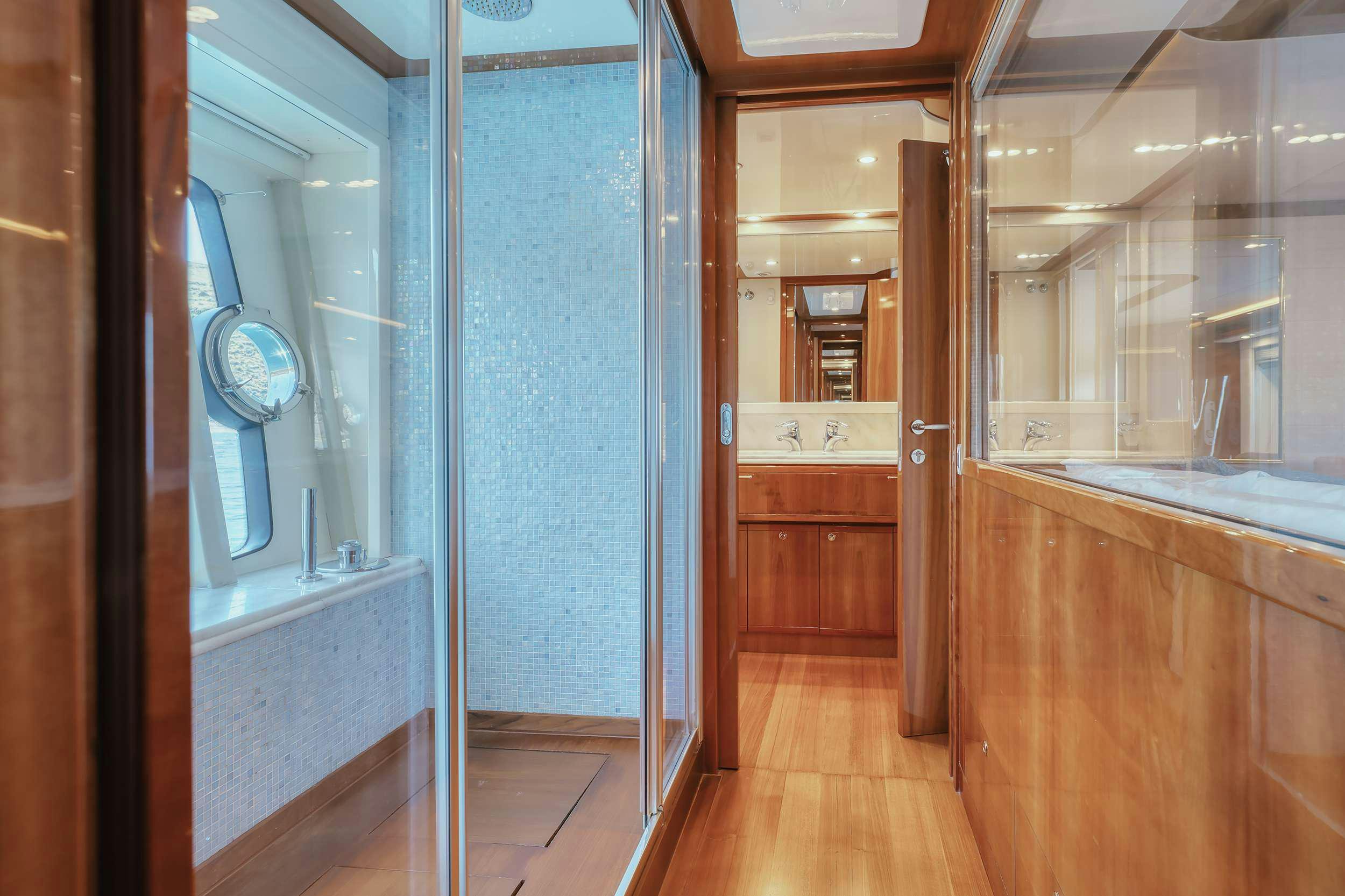 a room with a wood floor and a door with a window aboard LIDIA Yacht for Charter