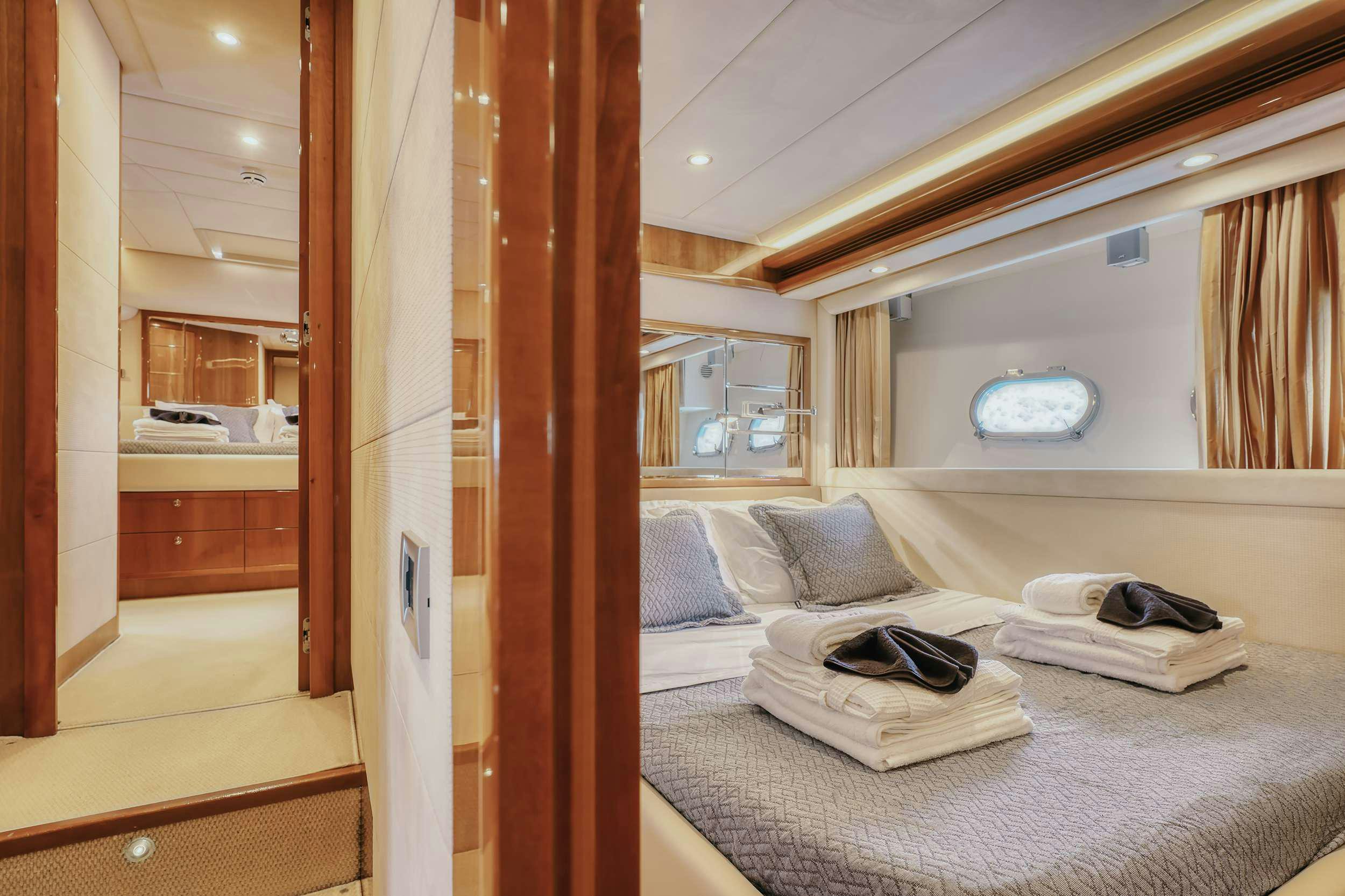 a bedroom with a bed and a closet aboard LIDIA Yacht for Charter