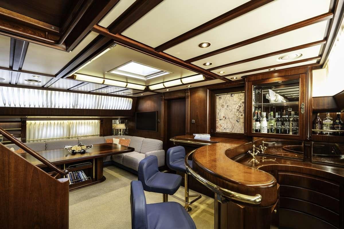 a room with a table chairs and a large window aboard COLOMBAIO Yacht for Charter