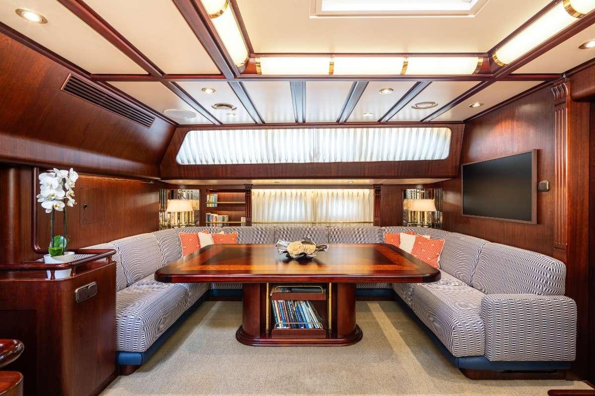 a room with a couch and a table aboard COLOMBAIO Yacht for Charter