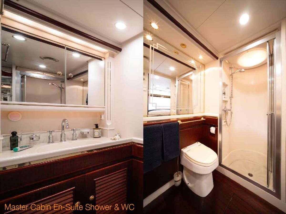a bathroom with a sink toilet and a mirror aboard COLOMBAIO Yacht for Charter