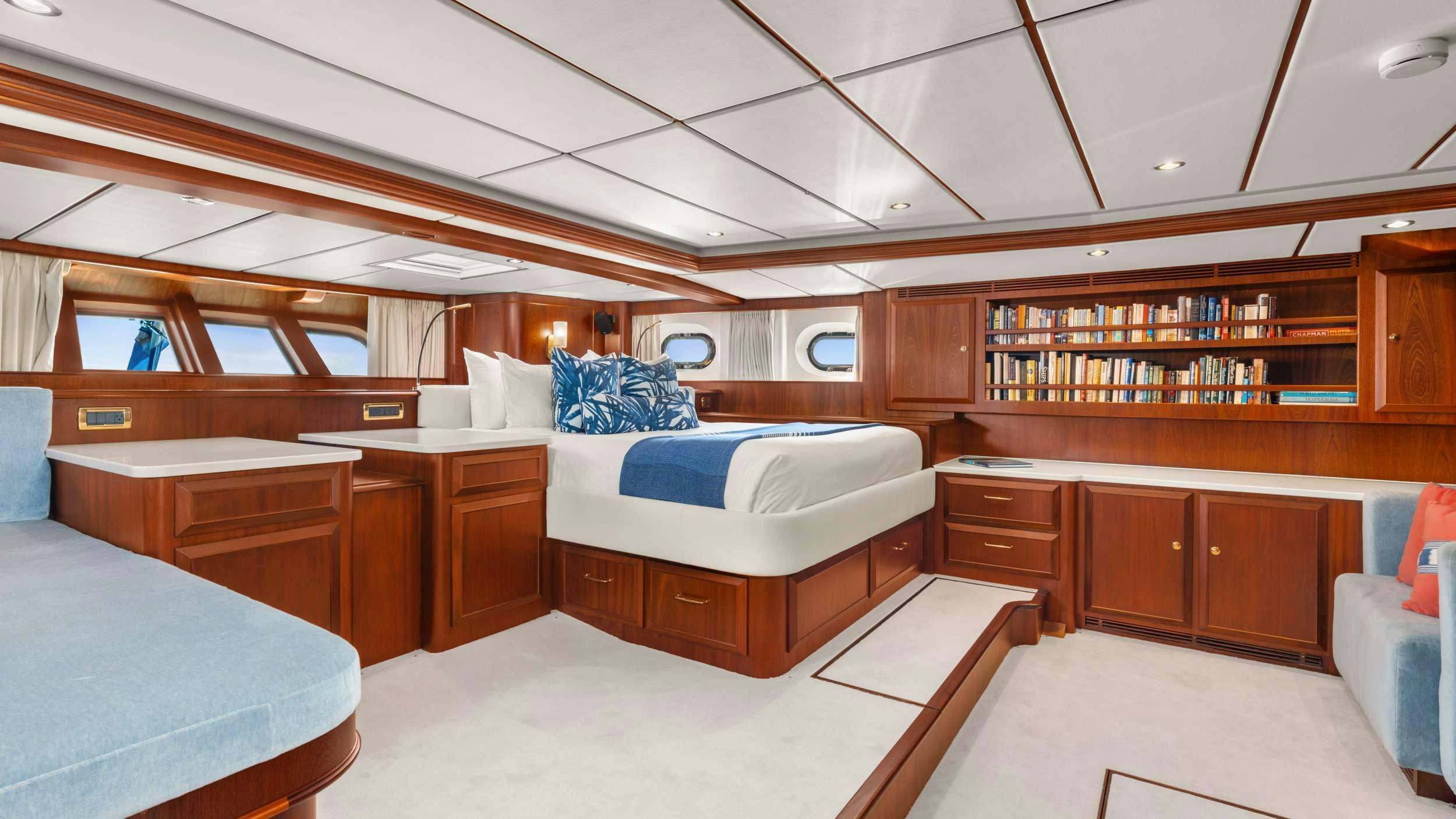 a room with wooden cabinets and a bed aboard ABIDE Yacht for Charter