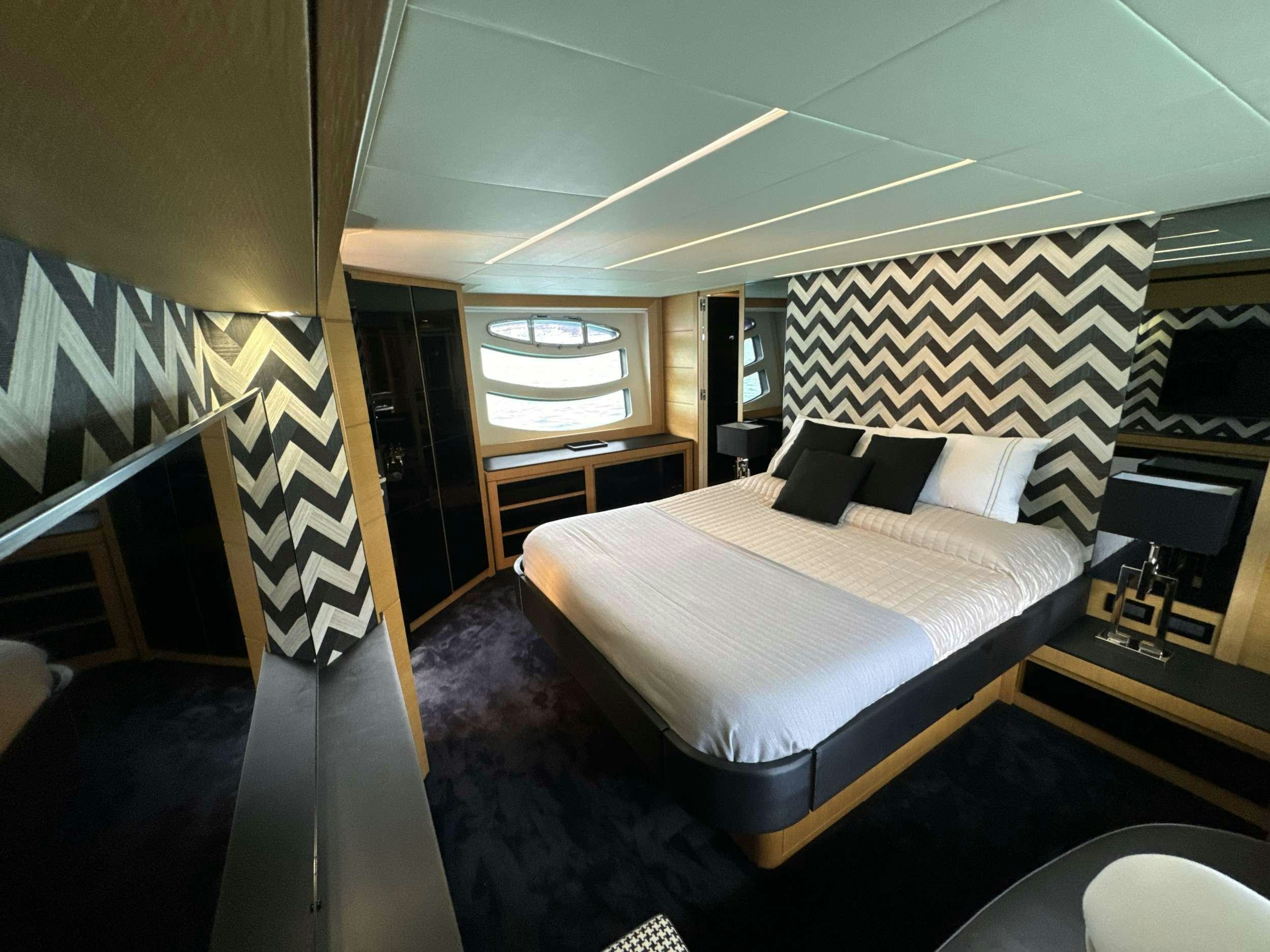 a bedroom with a bed and a desk aboard SUE&NTILDE;O Yacht for Charter