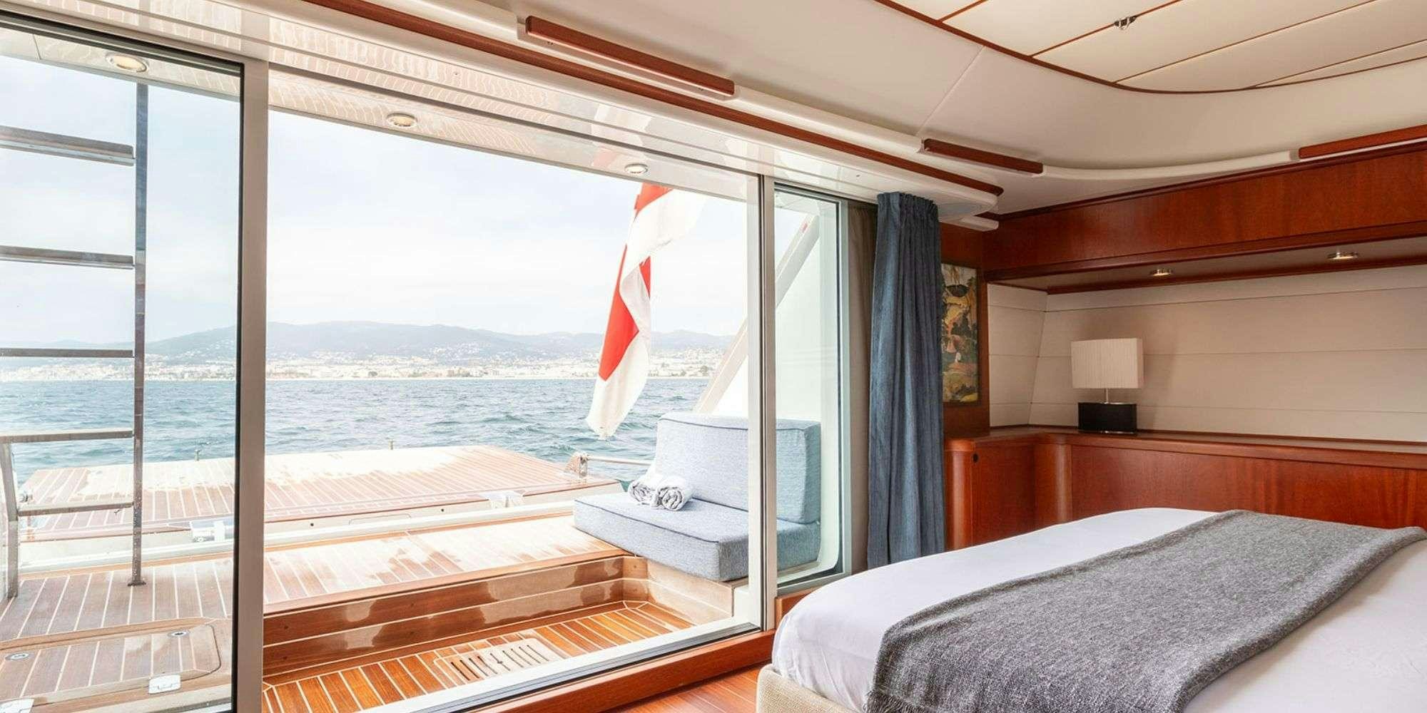 a room with a bed and a flag aboard SELENA Yacht for Charter