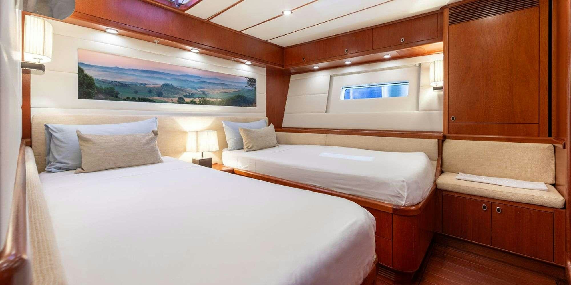 a room with two beds aboard SELENA Yacht for Charter