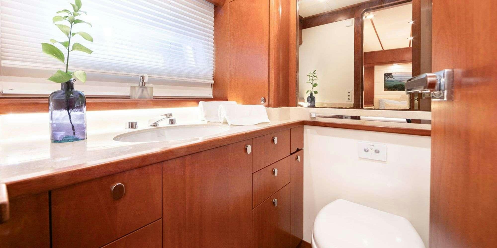 a bathroom with a sink and cabinets aboard SELENA Yacht for Charter