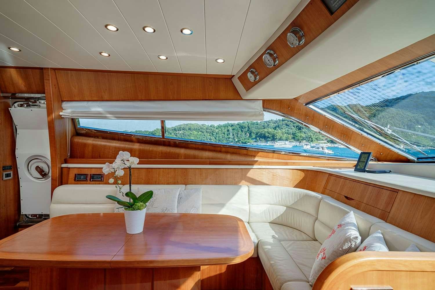 a room with a table and a couch aboard ROCK MOON Yacht for Charter