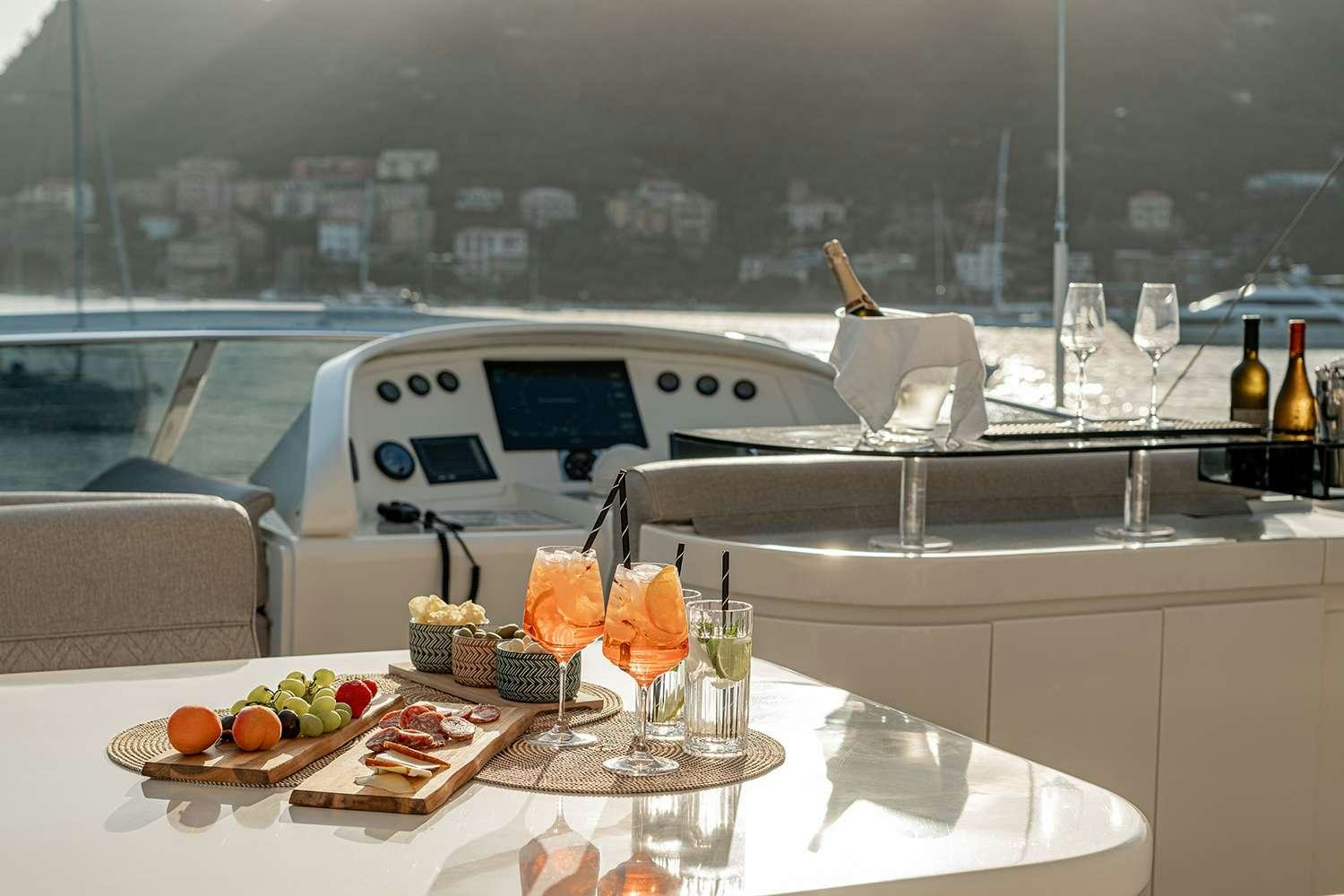 a table with food and drinks on it aboard ROCK MOON Yacht for Charter