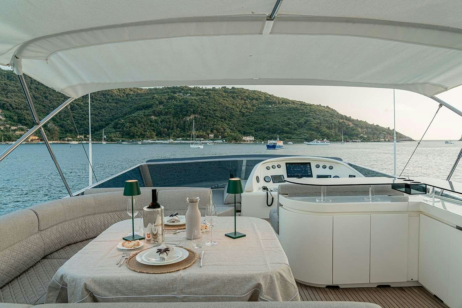 a table with a plate and a bottle on it aboard ROCK MOON Yacht for Charter