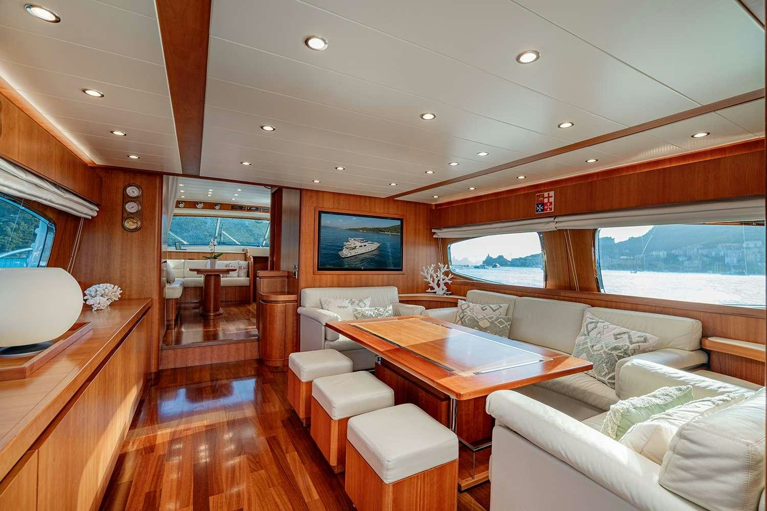 a living room with a table and chairs aboard ROCK MOON Yacht for Charter