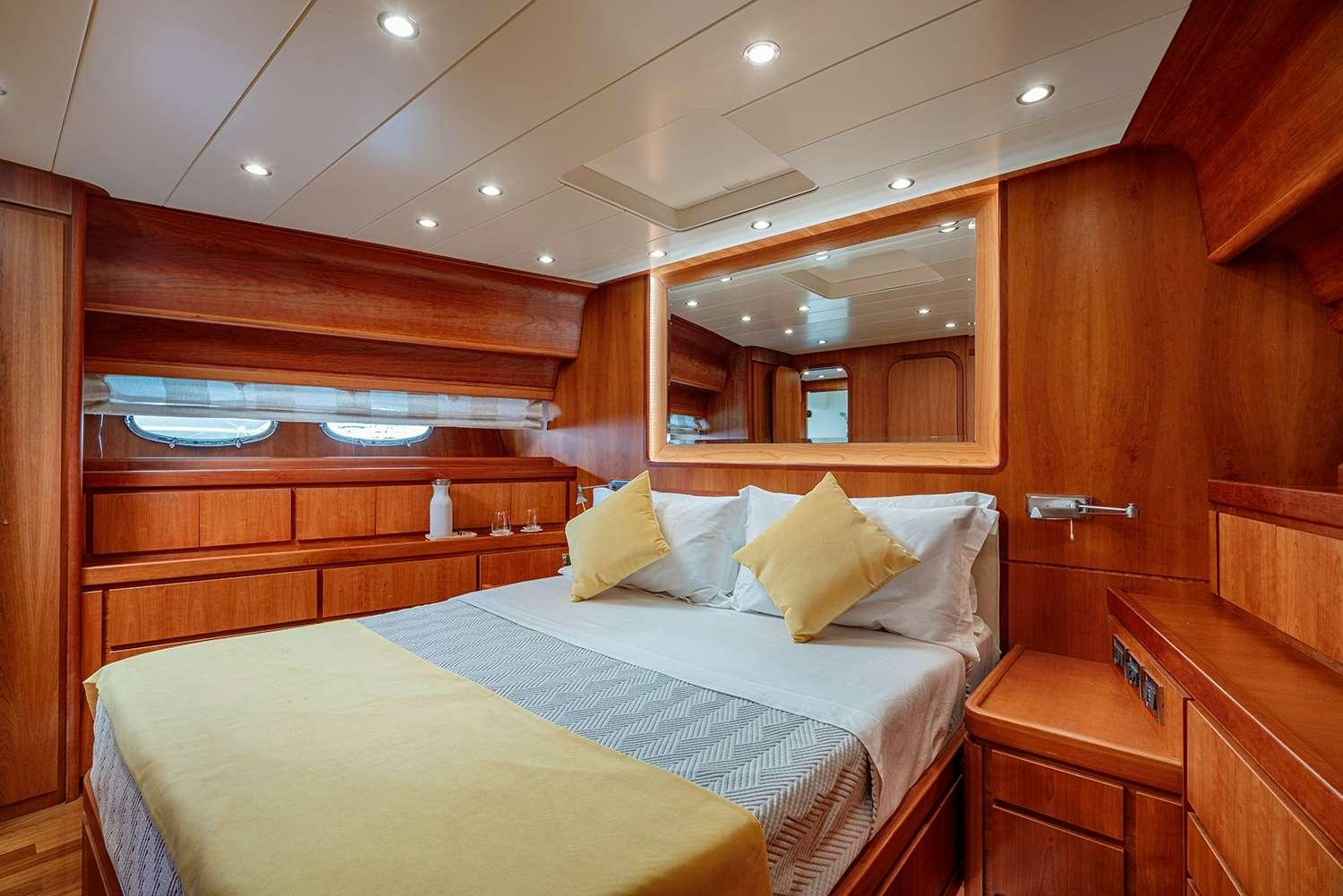 a bed with a blue sheet aboard ROCK MOON Yacht for Charter