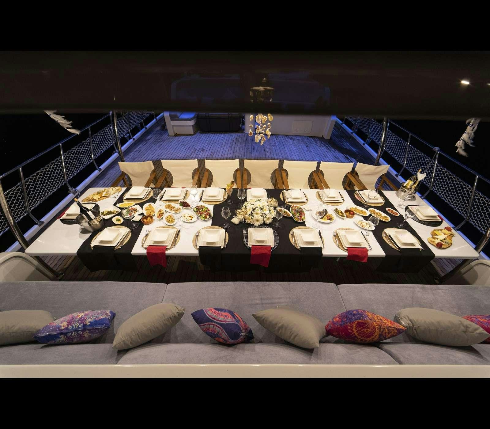 a bed with many small boxes on it aboard QUEEN OF RTT GULET Yacht for Charter