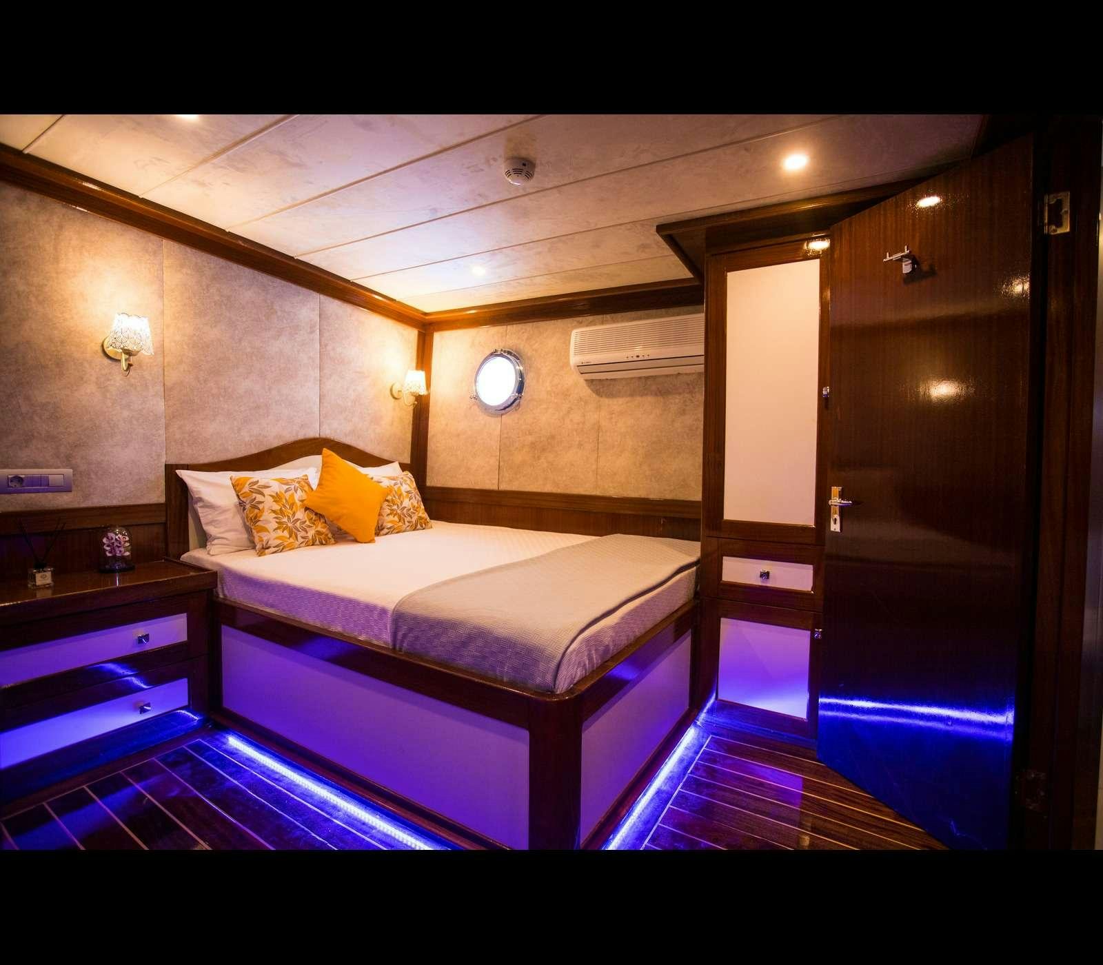 a bed in a room aboard QUEEN OF RTT GULET Yacht for Charter