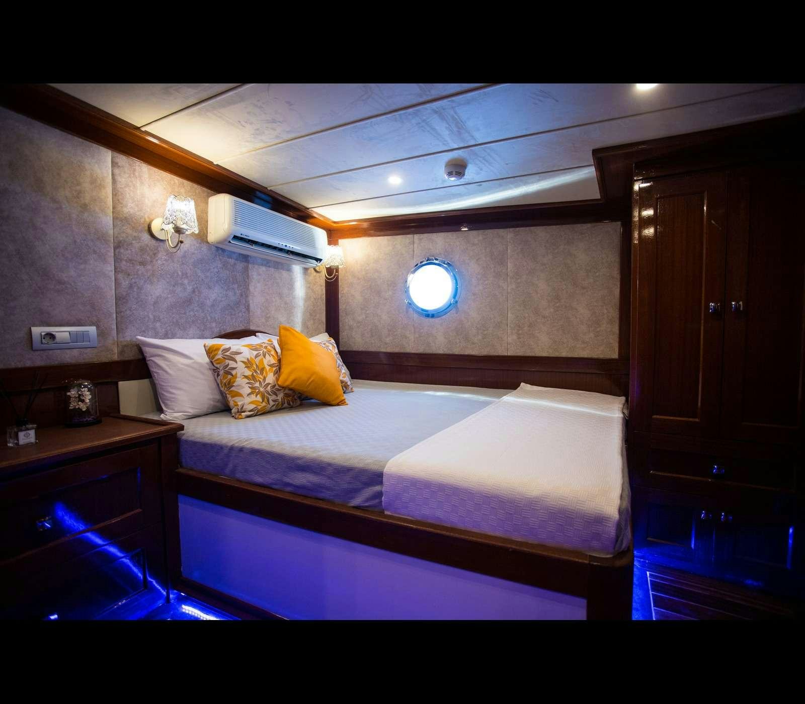 a bed in a room aboard QUEEN OF RTT GULET Yacht for Charter