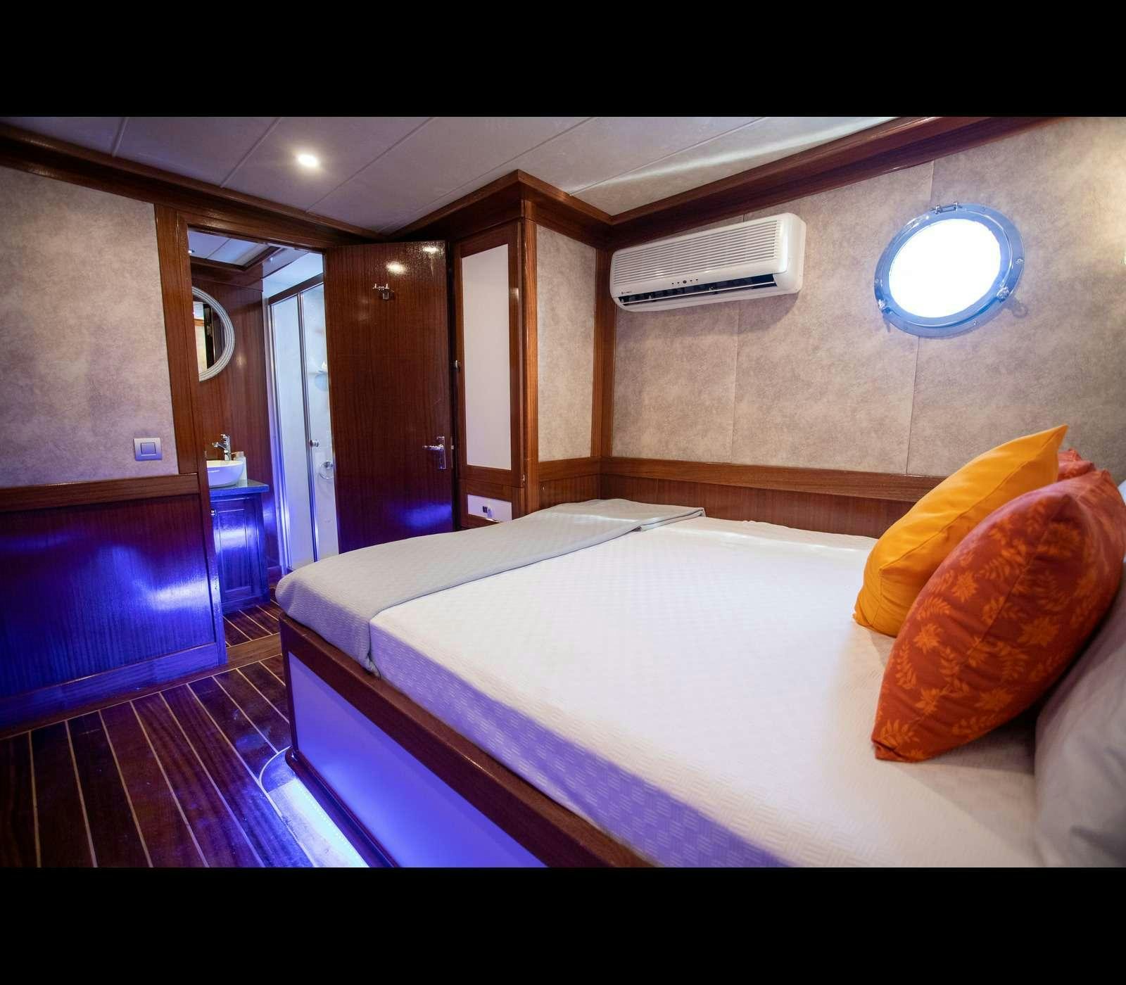 a bed in a room aboard QUEEN OF RTT GULET Yacht for Charter
