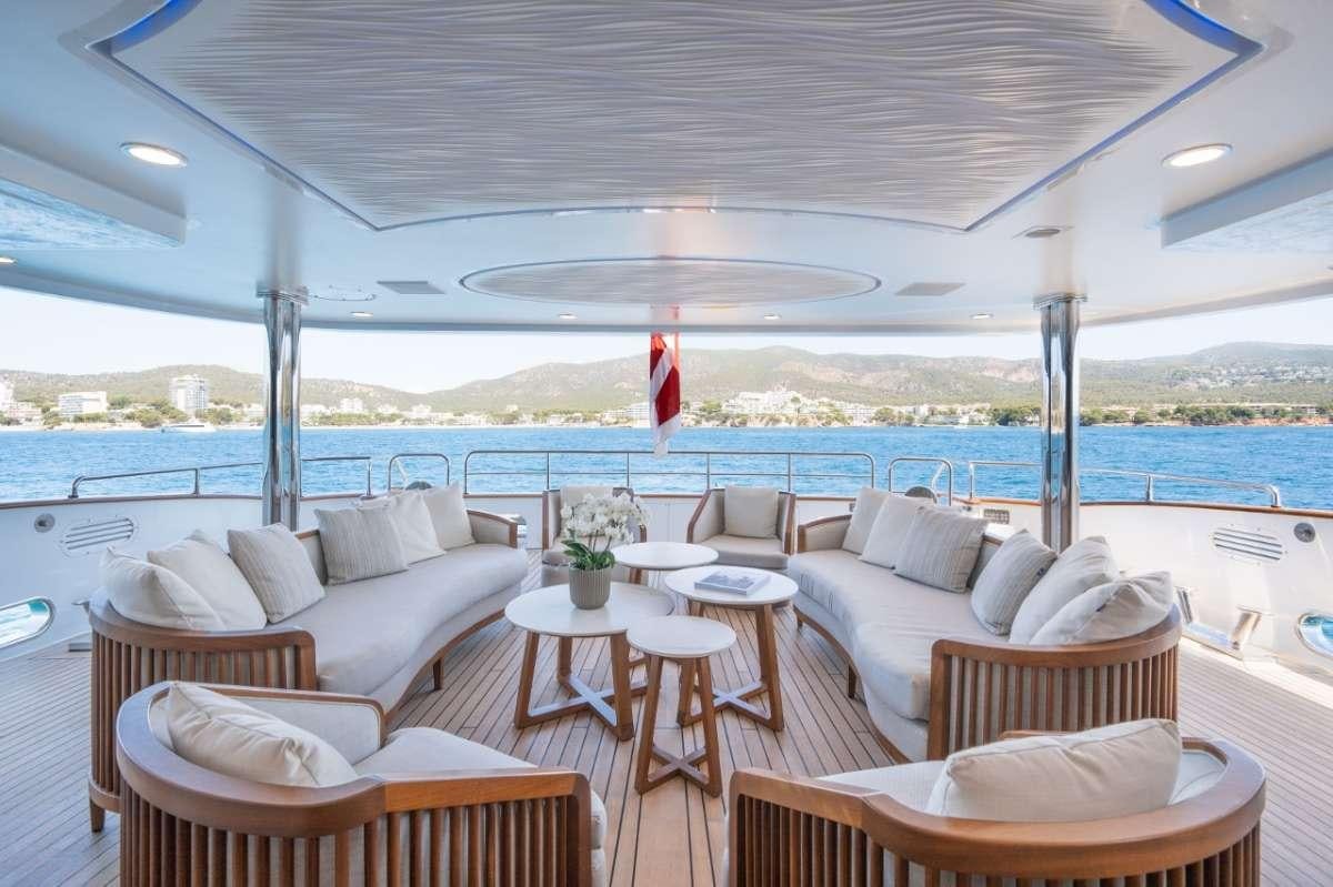 a room with couches and tables aboard TITIAN PEARL Yacht for Charter