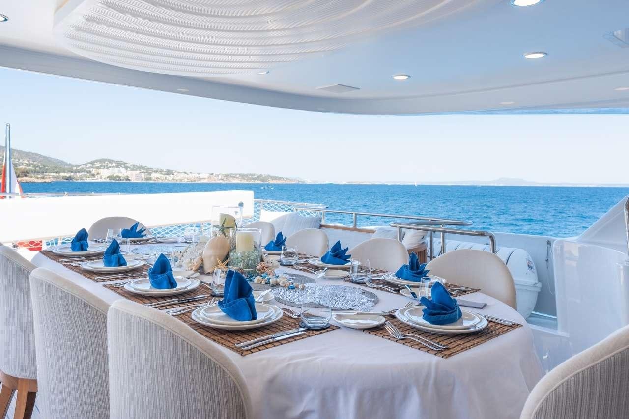 a table set for a dinner aboard TITIAN PEARL Yacht for Charter