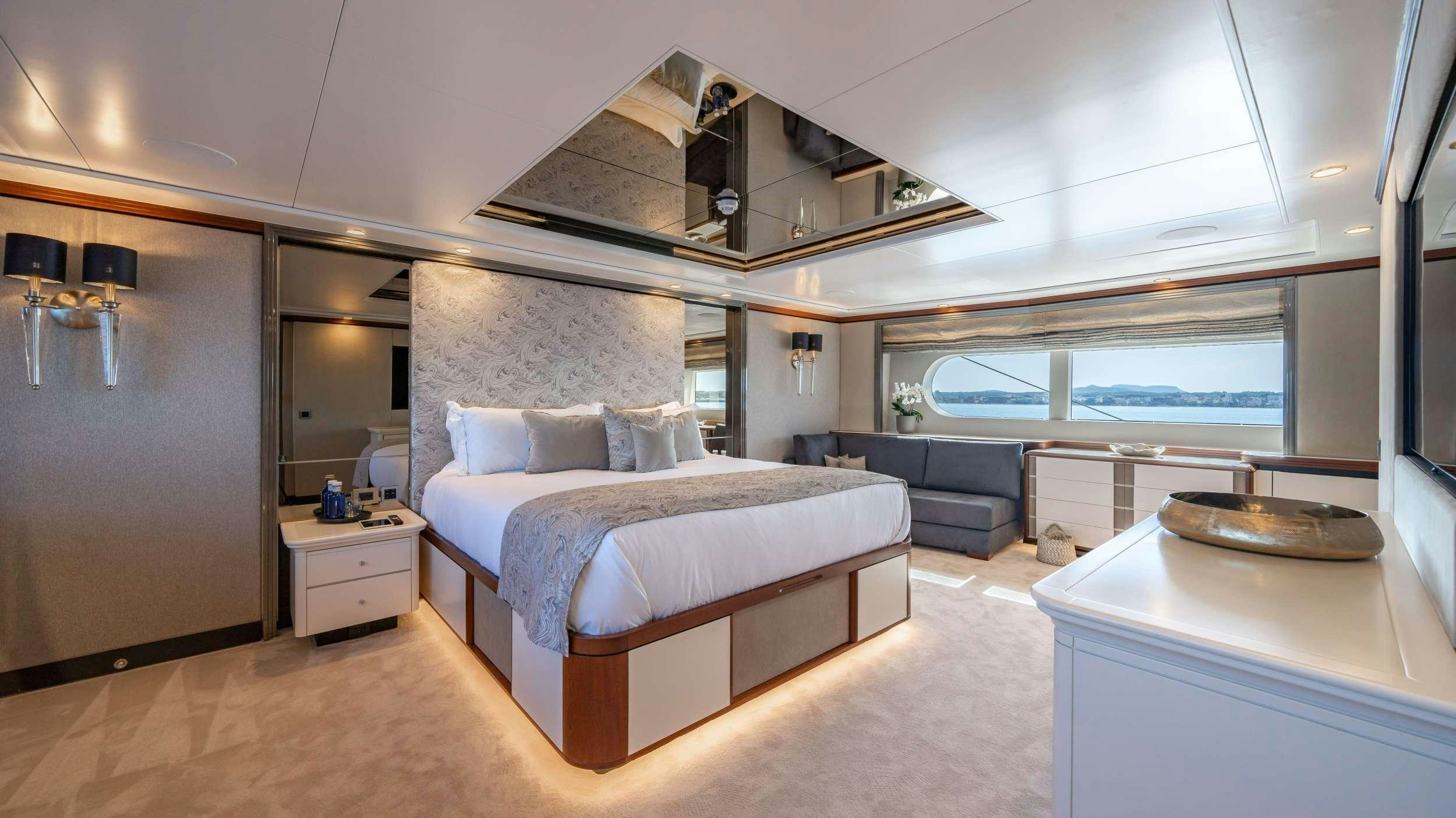 a large bedroom with a large bed aboard TITIAN PEARL Yacht for Charter