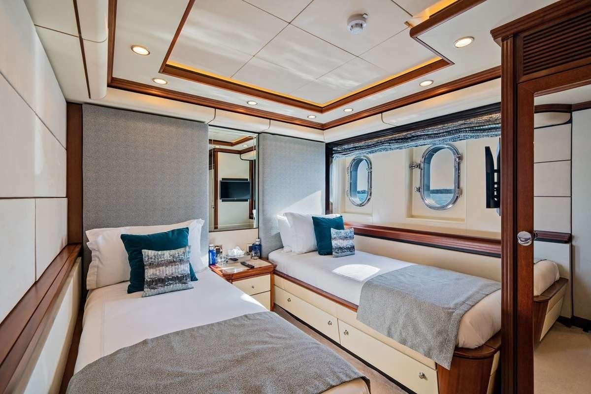 a couple of beds in a hotel room aboard TITIAN PEARL Yacht for Charter