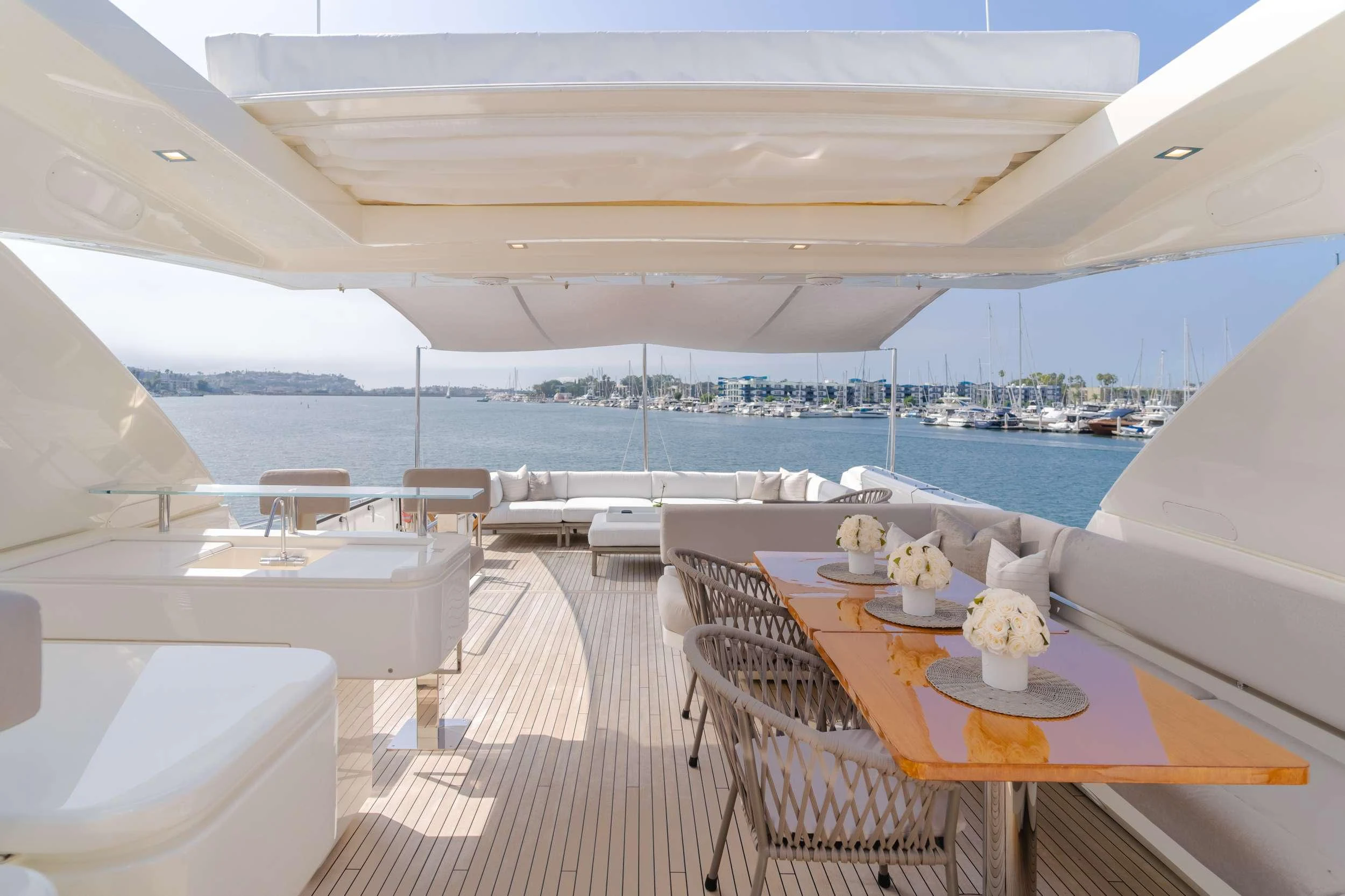 a large white boat with a table and chairs on a deck aboard SOL SHINE Yacht for Charter