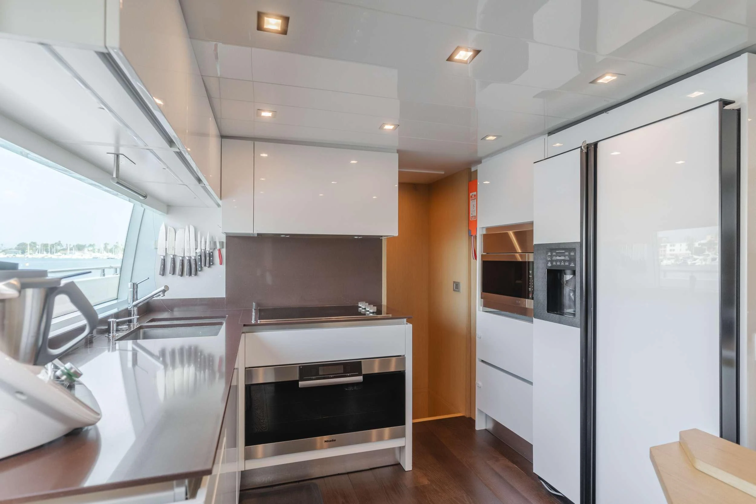 a kitchen with white cabinets aboard SOL SHINE Yacht for Charter