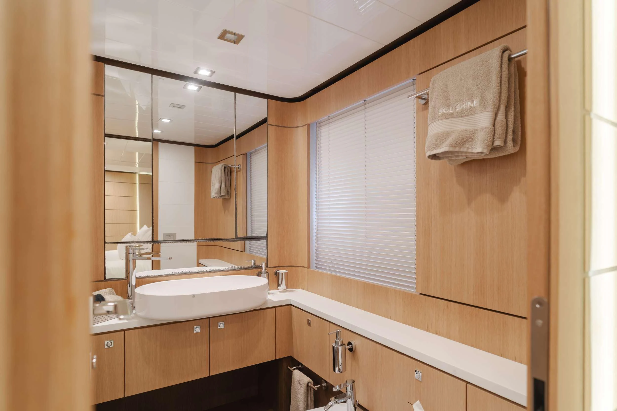 a bathroom with a mirror and sink aboard SOL SHINE Yacht for Charter