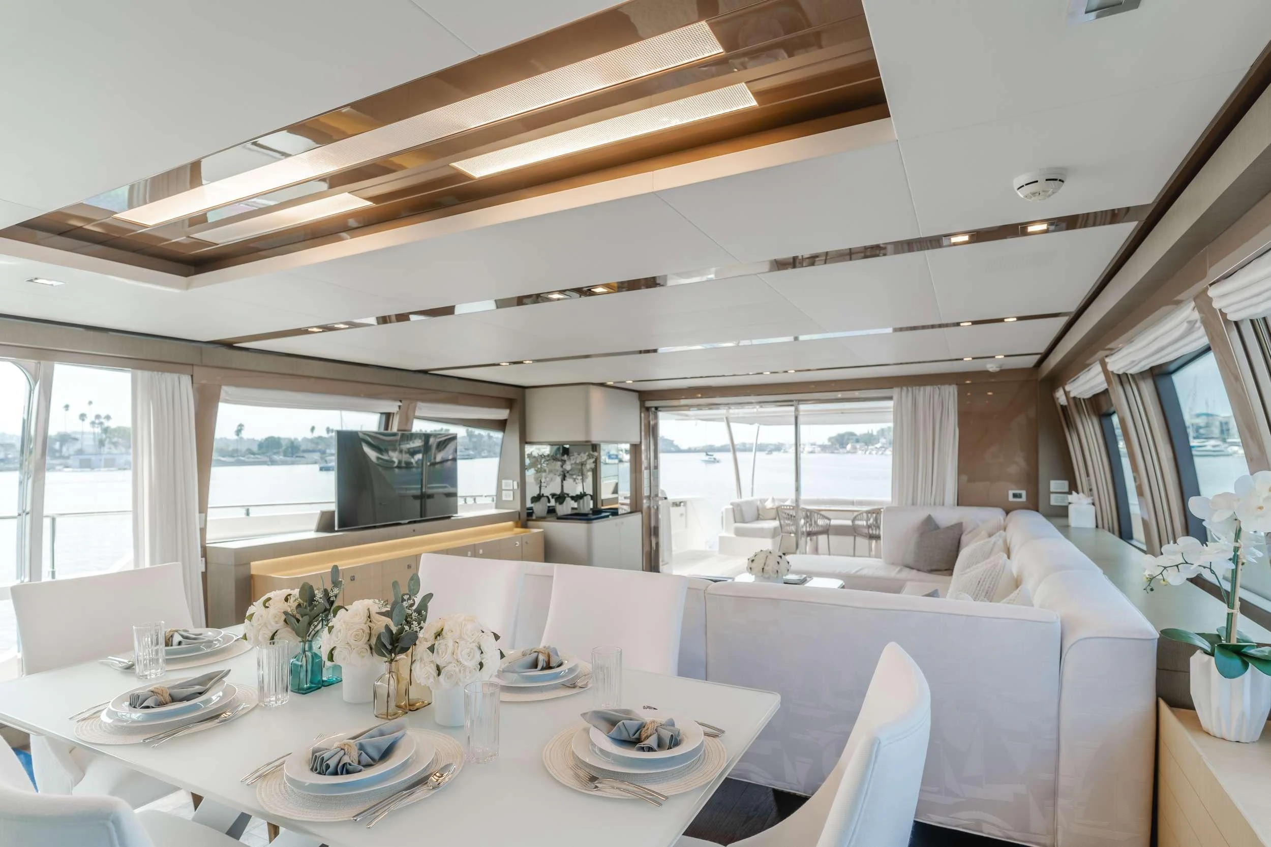 a dining room with a large window aboard SOL SHINE Yacht for Charter