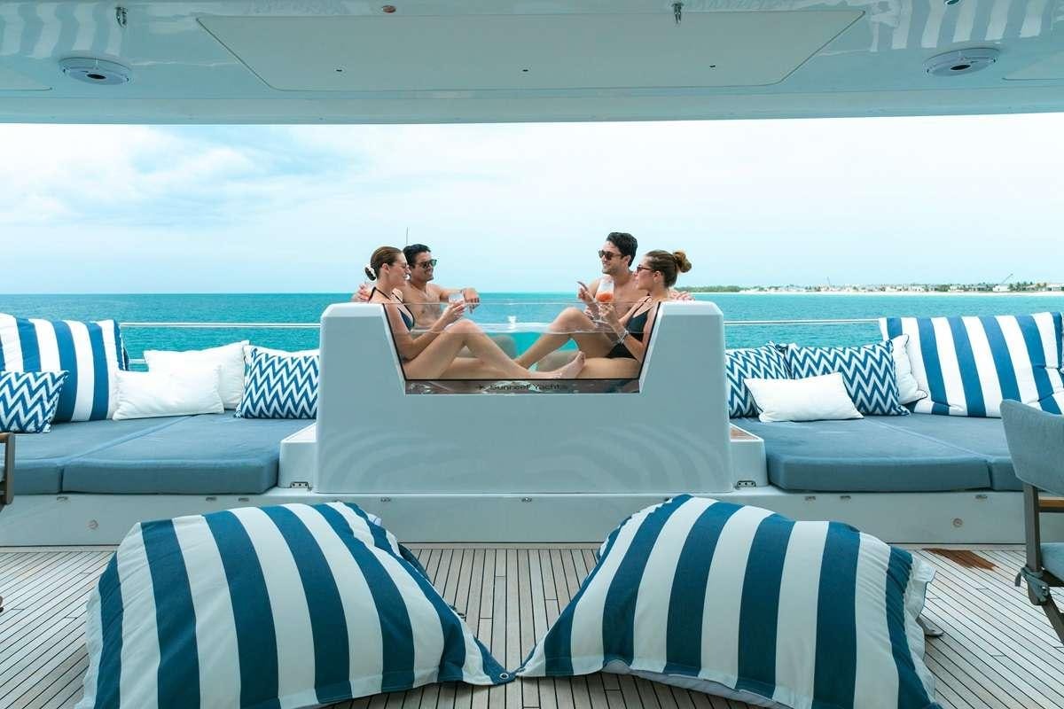 a group of people sitting on a couch in a boat aboard BLESSED Yacht for Charter