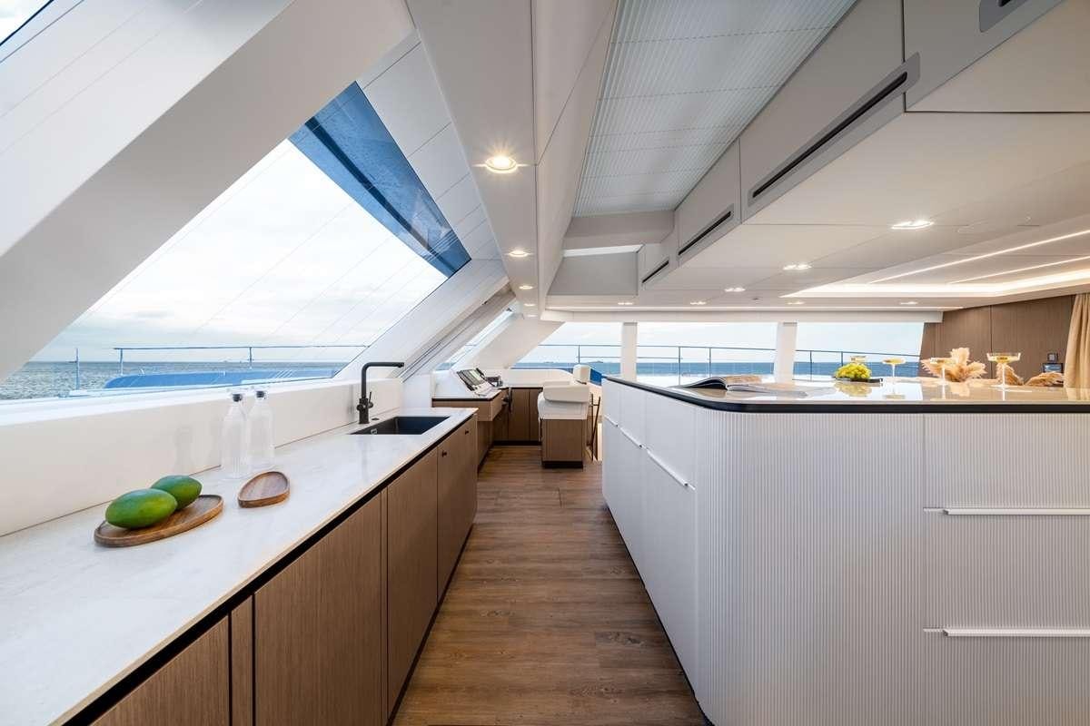 a kitchen with a large island aboard BLESSED Yacht for Charter