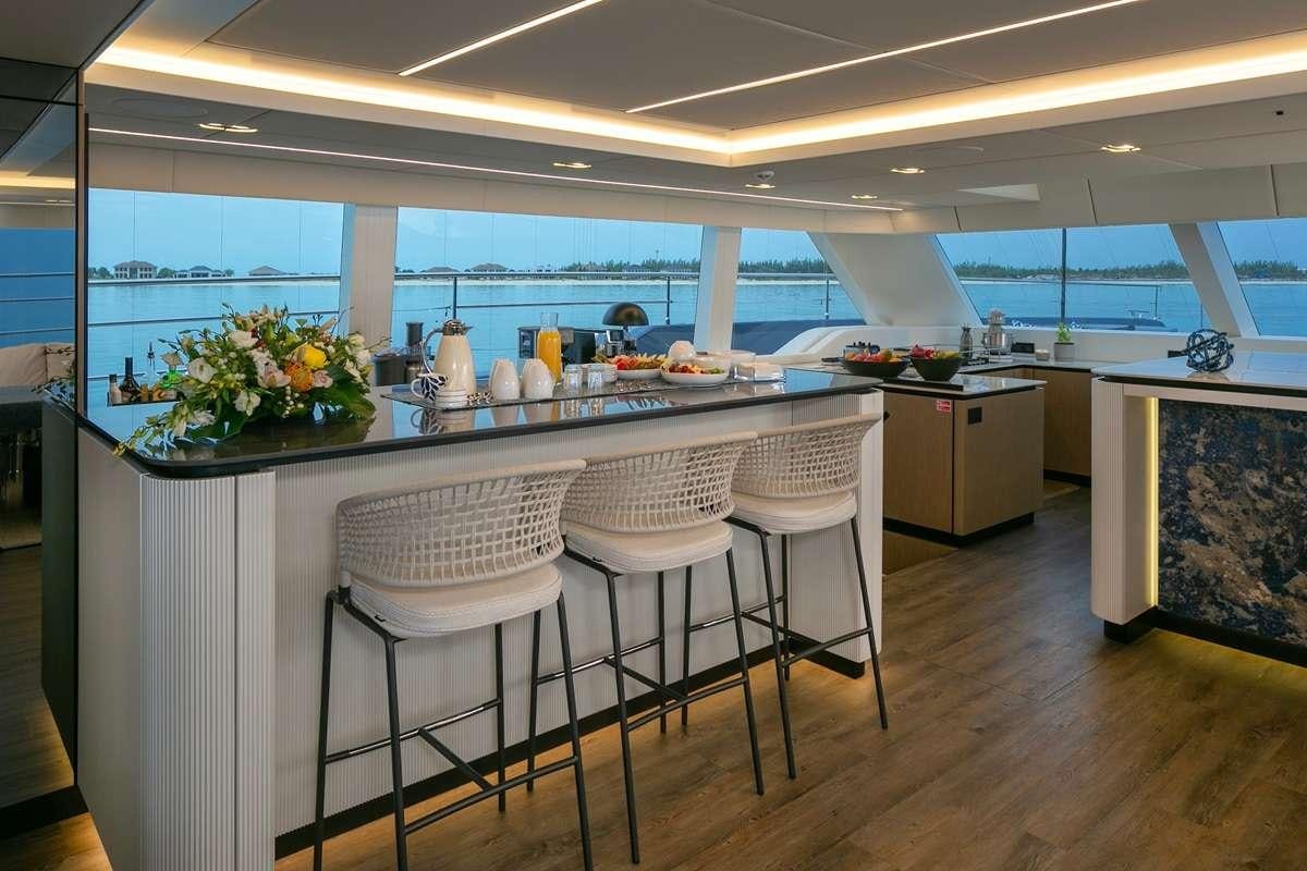 a kitchen with a table and chairs aboard BLESSED Yacht for Charter