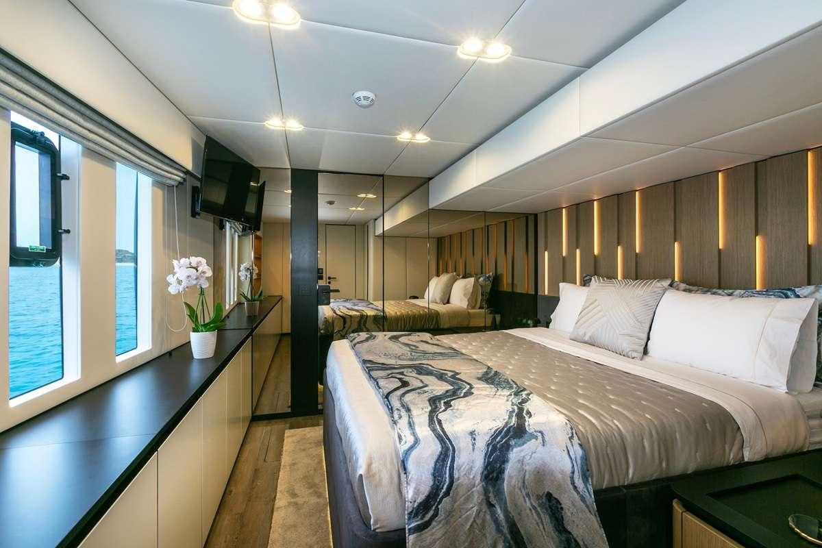a bedroom with a bed and a couch aboard BLESSED Yacht for Charter
