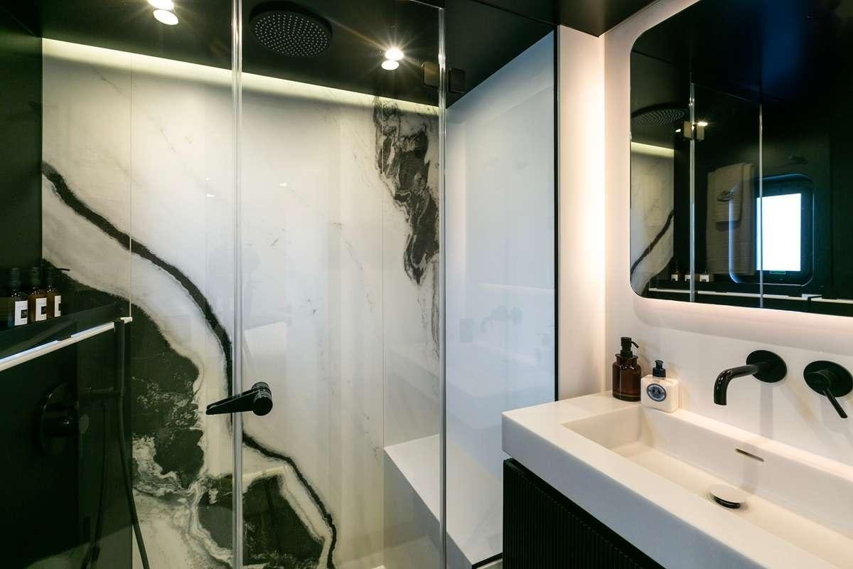 a bathroom with a shower curtain aboard BLESSED Yacht for Charter