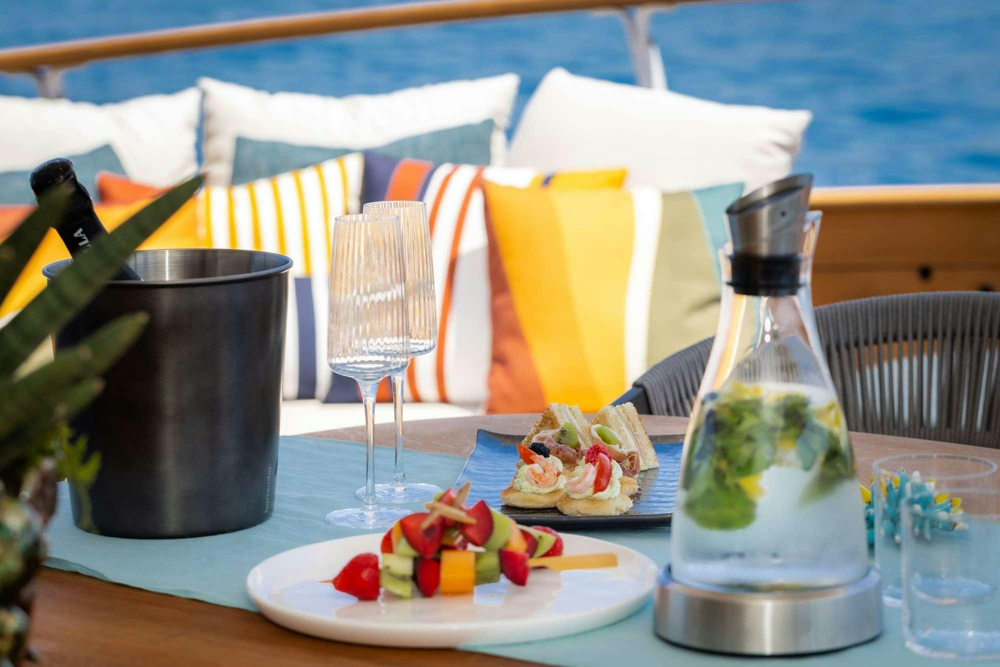 a table with food and drinks aboard OLGA Yacht for Charter