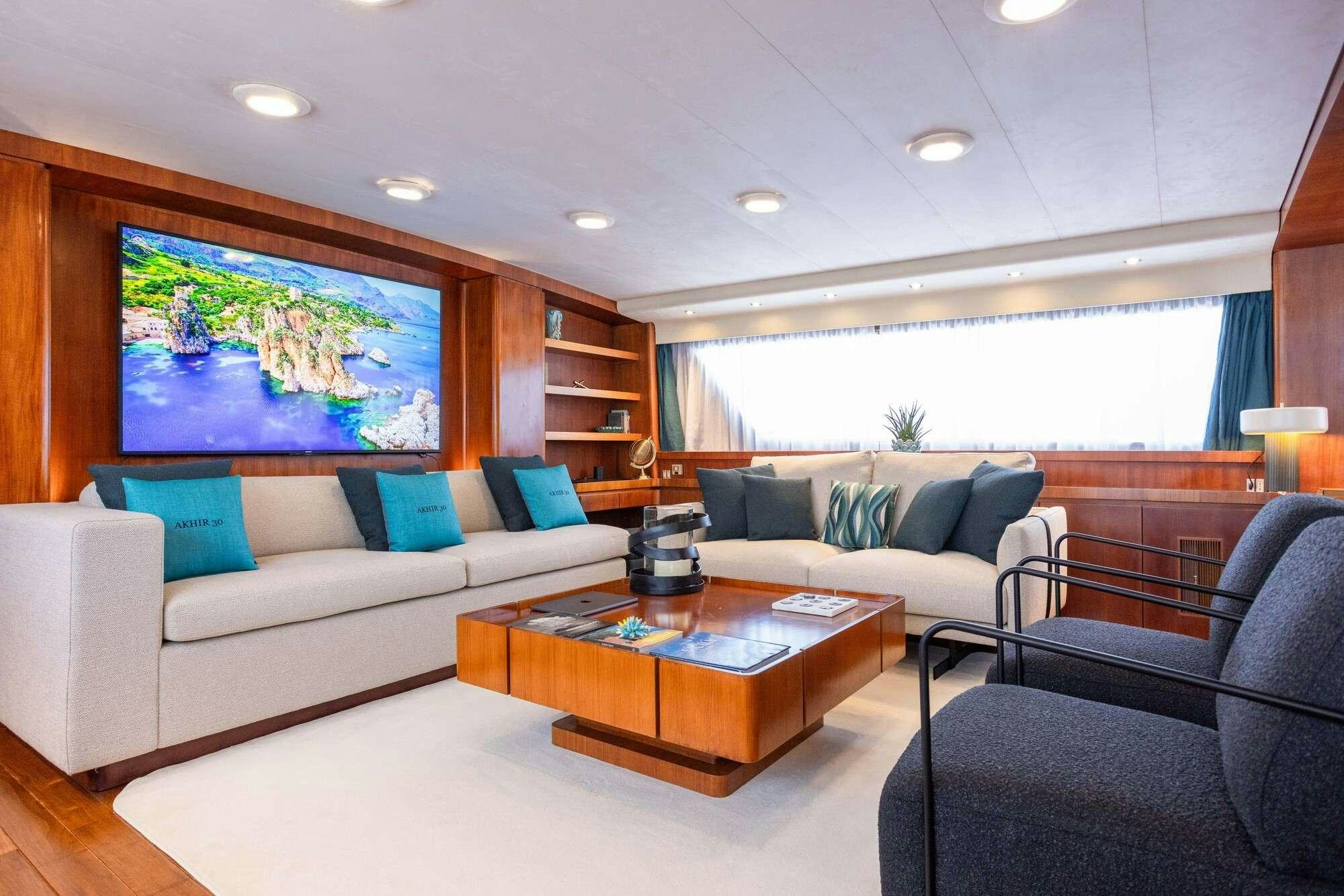 a living room with a large screen aboard OLGA Yacht for Charter