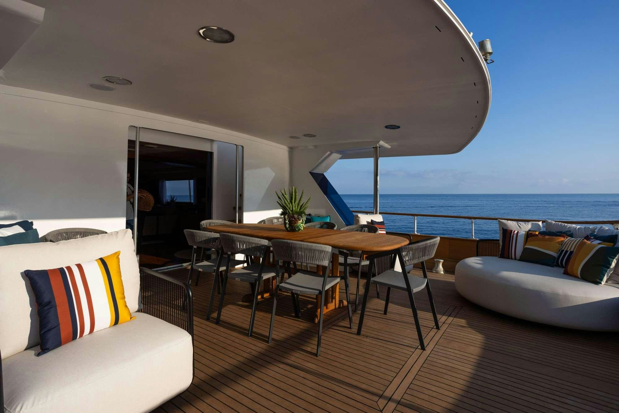 a room with a table and chairs aboard OLGA Yacht for Charter