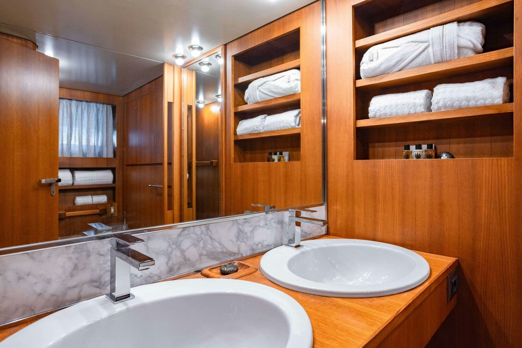 a bathroom with a sink and a mirror aboard OLGA Yacht for Charter