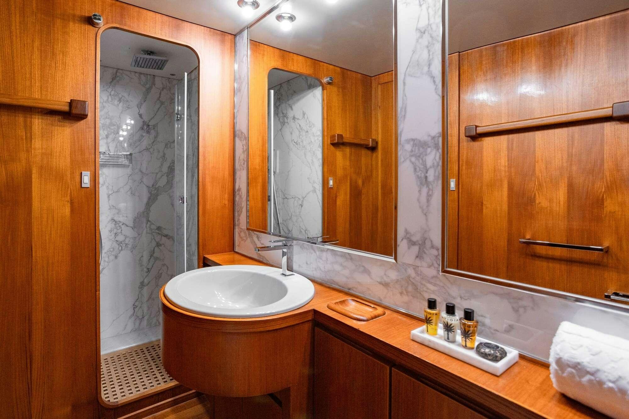 a bathroom with a large mirror aboard OLGA Yacht for Charter