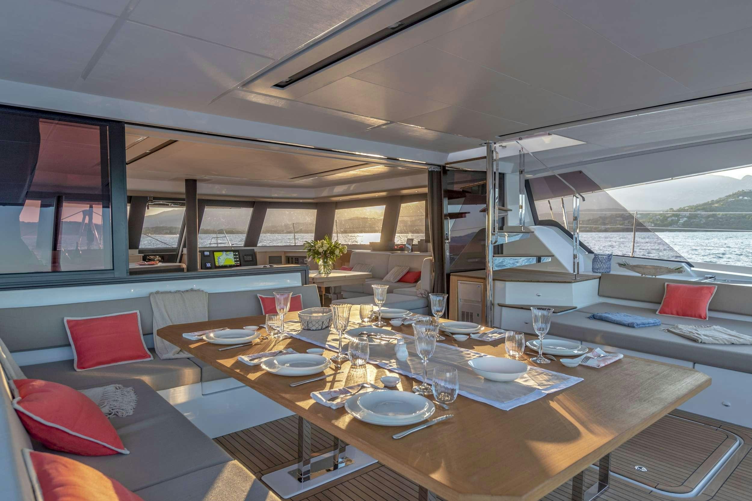 a table with plates and glasses on it aboard FLORAMYE Yacht for Charter