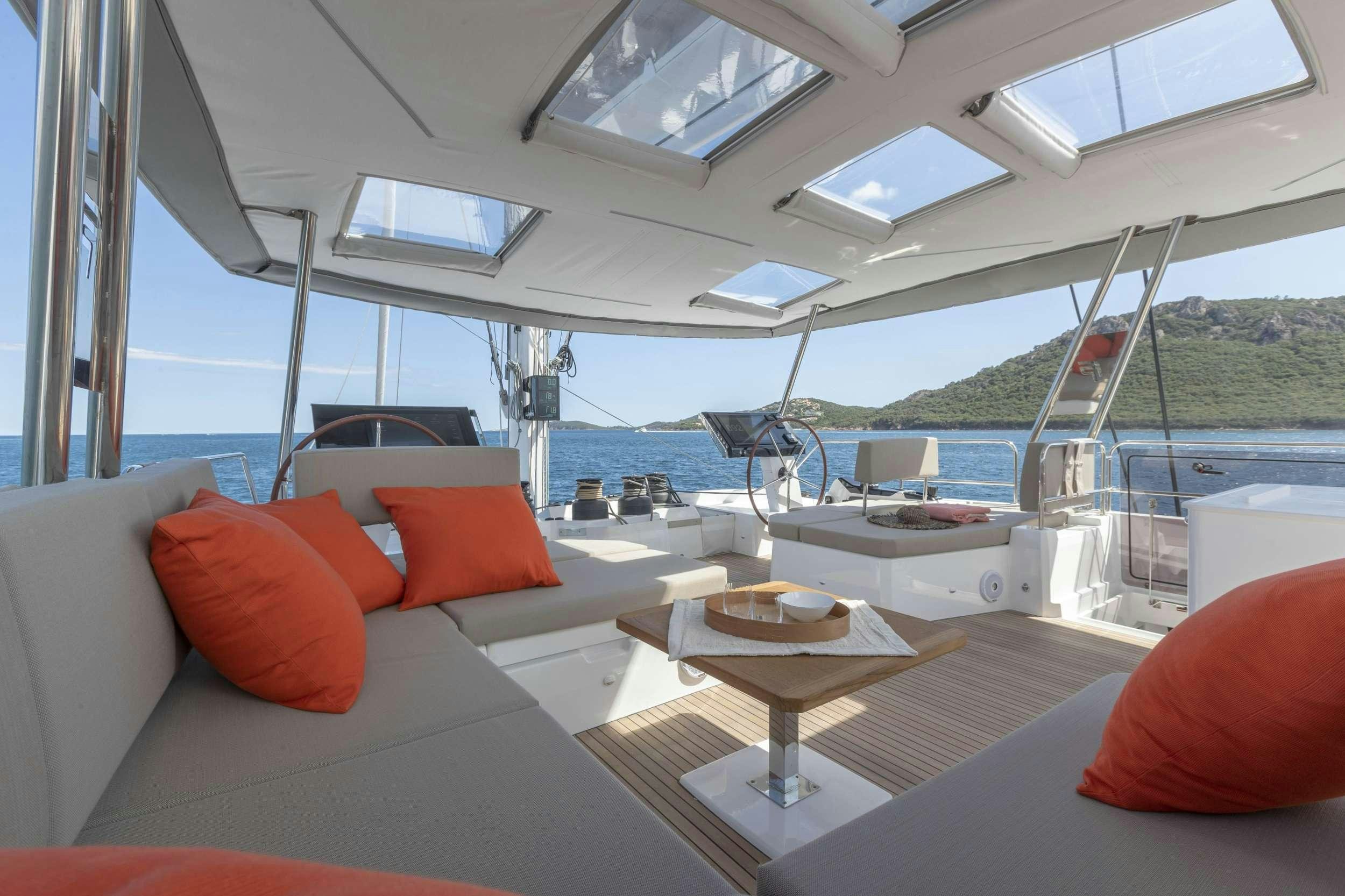 a boat with pillows and a table aboard FLORAMYE Yacht for Charter