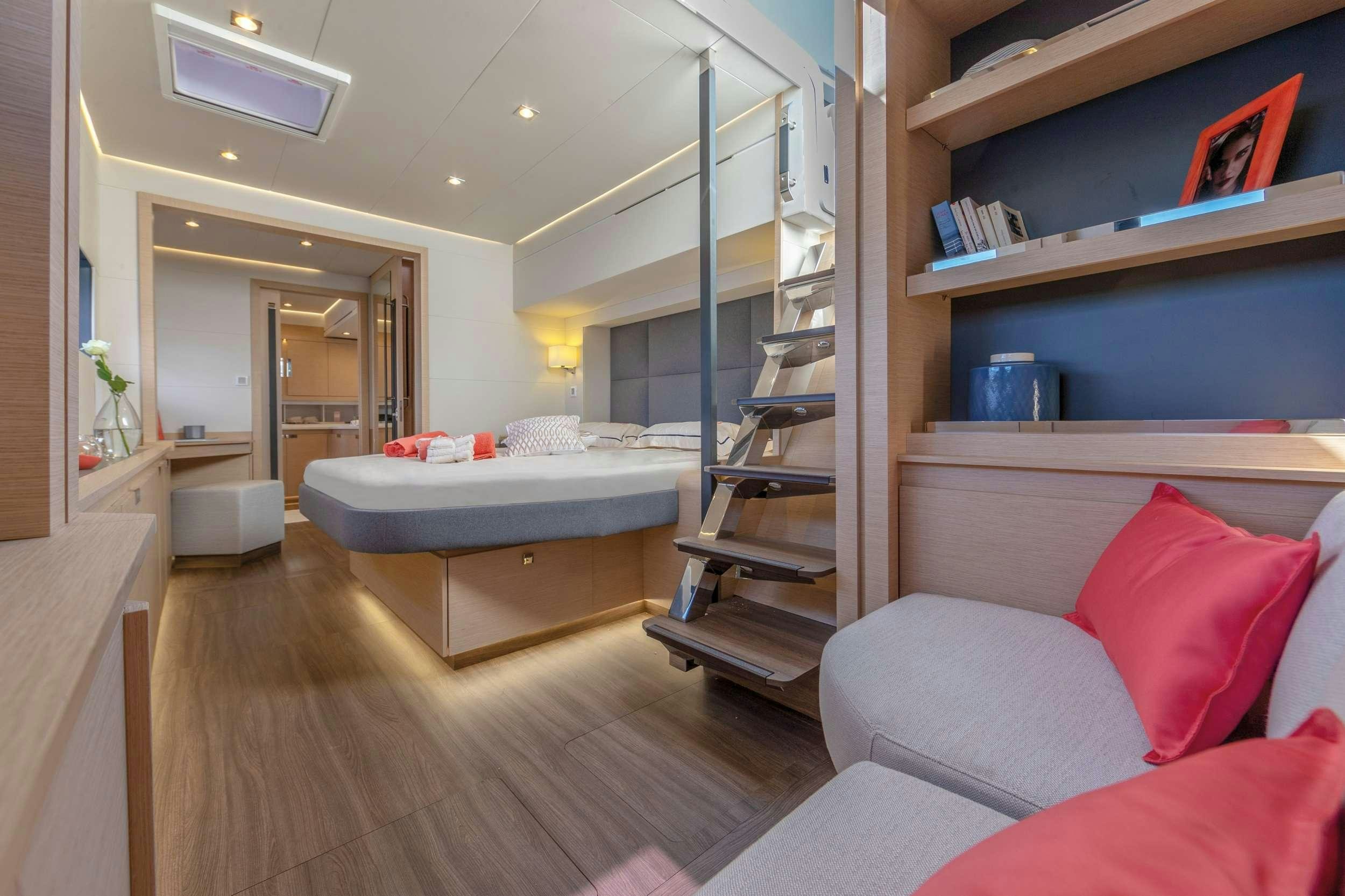 a bedroom with a bed and a bookcase aboard FLORAMYE Yacht for Charter