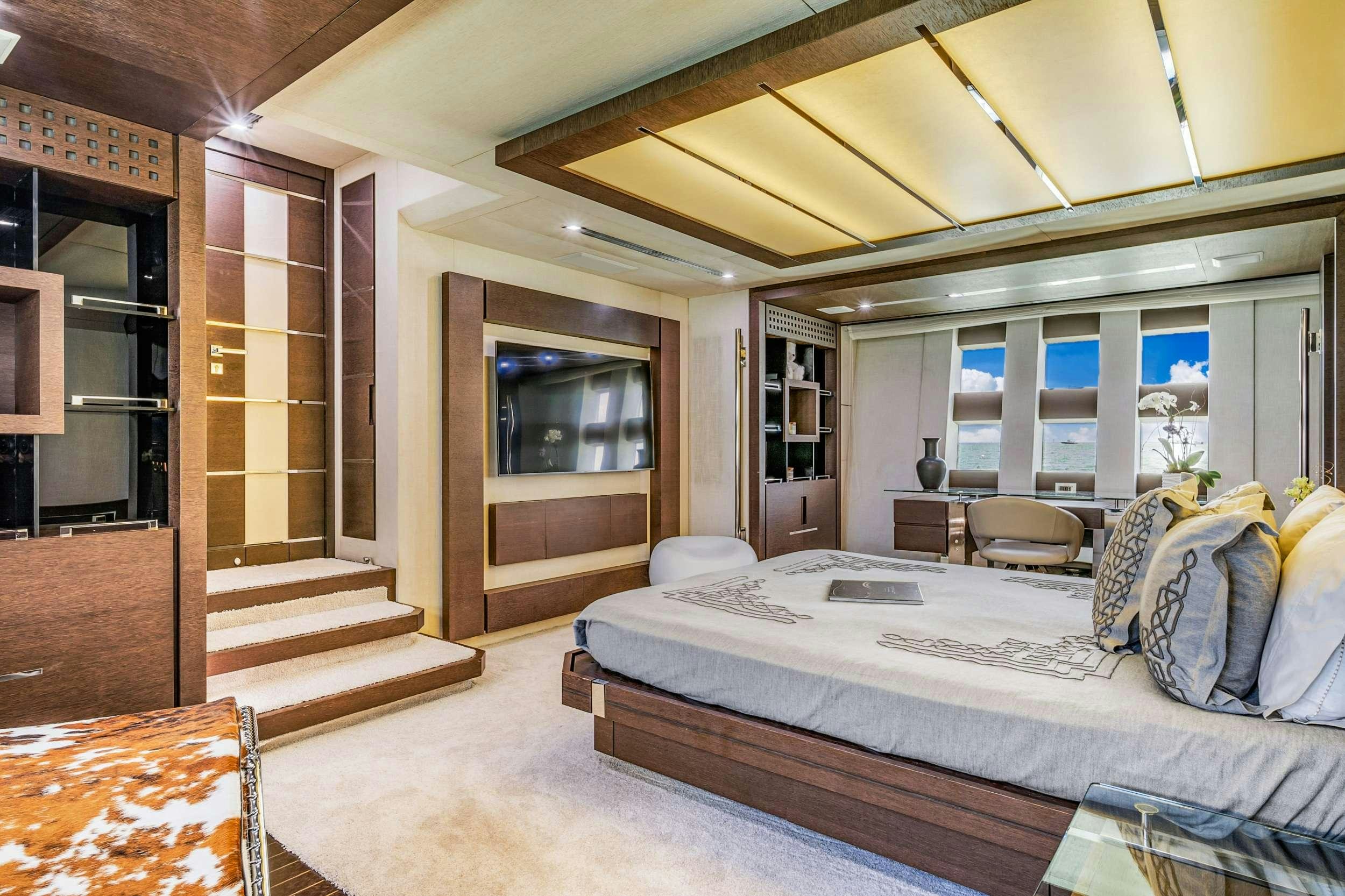 a bedroom with a bed and a table aboard SETTE Yacht for Charter