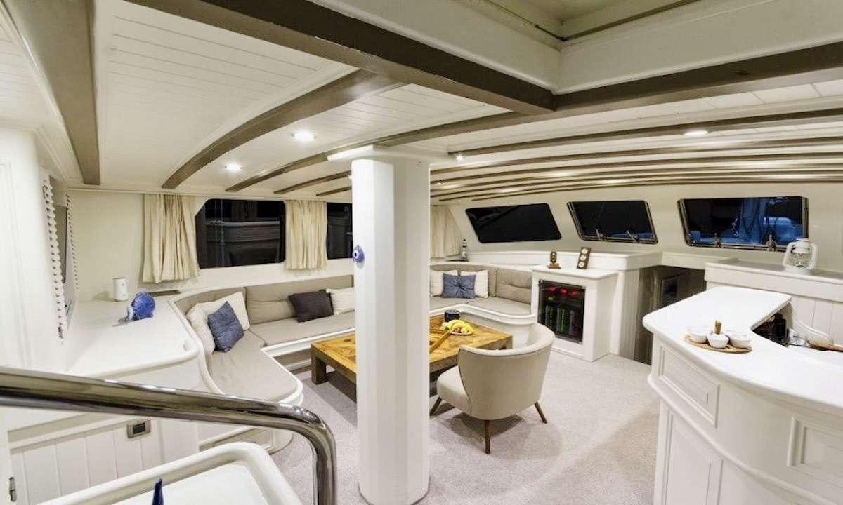 a room with a bed and a desk aboard THE BLUE SEA Yacht for Charter