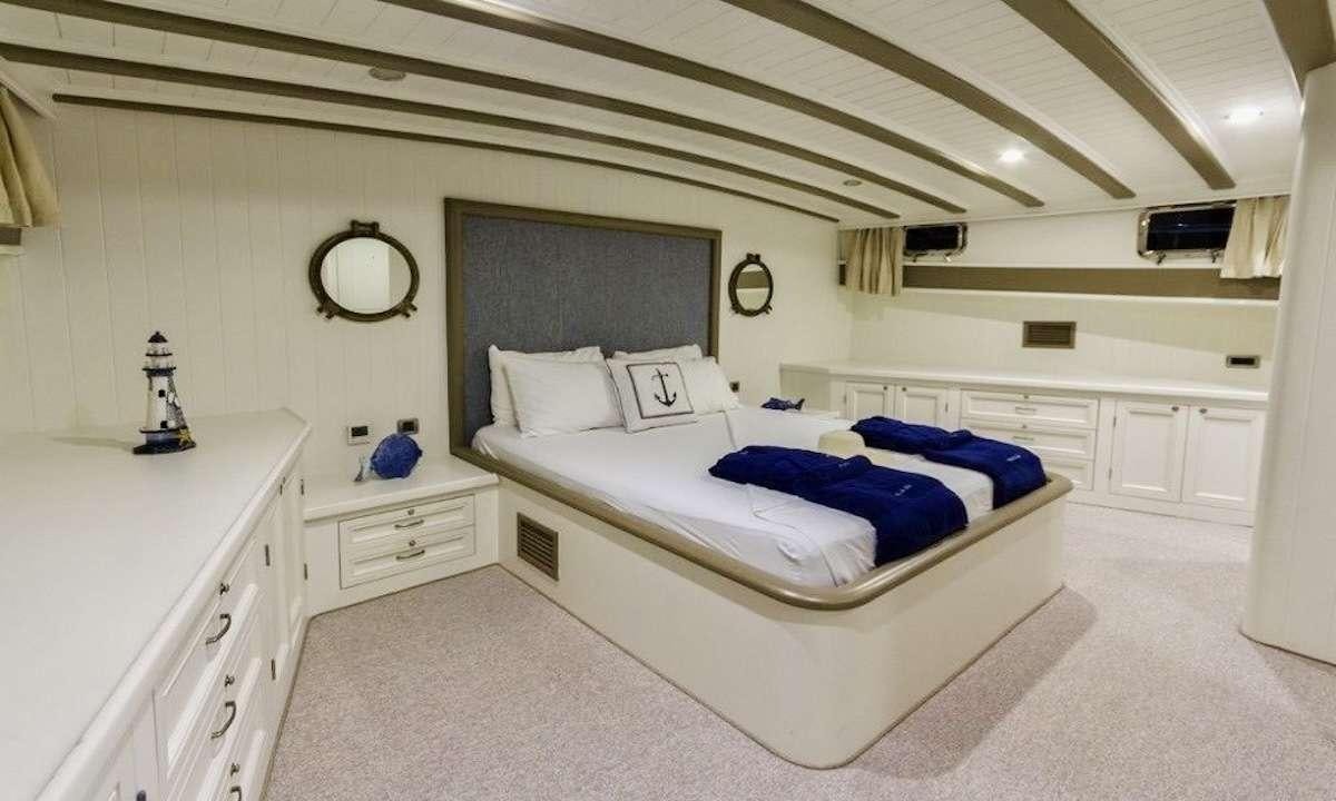 a large bedroom with a large bed aboard THE BLUE SEA Yacht for Charter